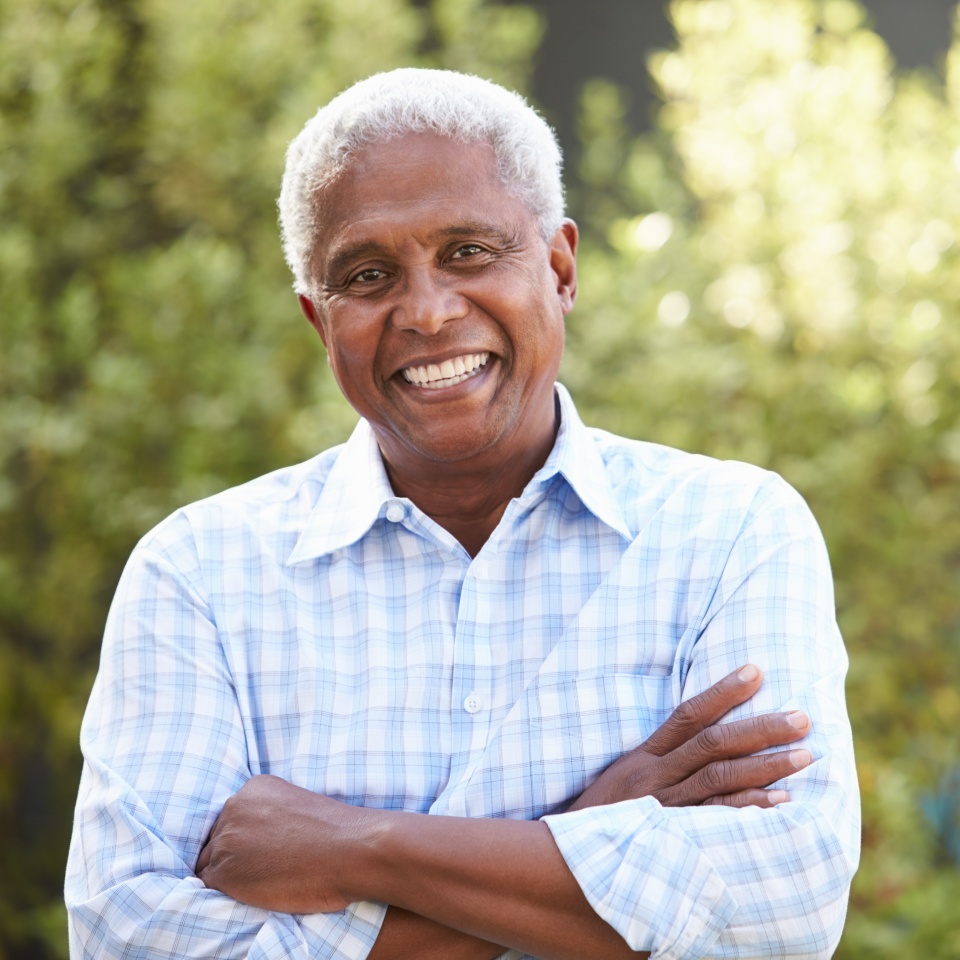 Smiling senior African American man with arms crossed