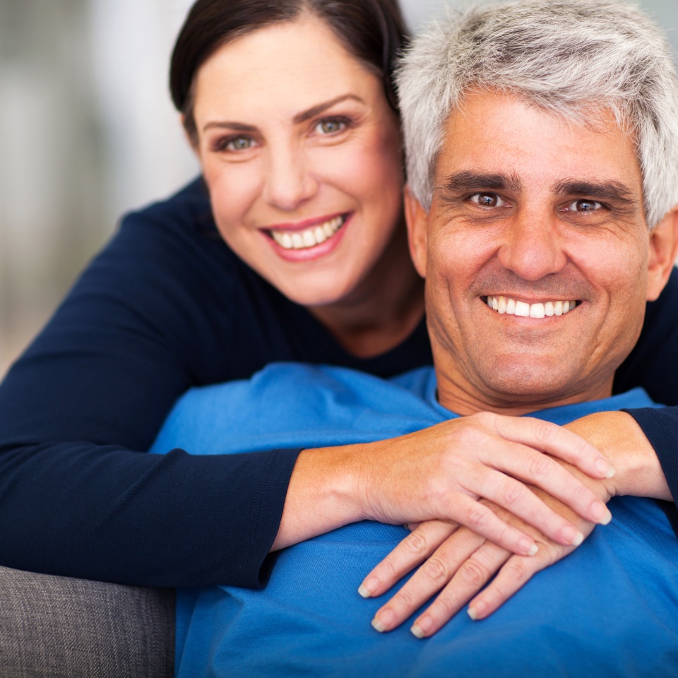 happy loving middle aged couple relaxing at home