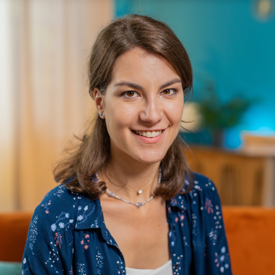 Portrait of happy calm Caucasian woman at home couch smiling friendly, glad expression looking at camera resting, relaxation feel satisfied good news, celebrate win. Smiling young girl in living room.